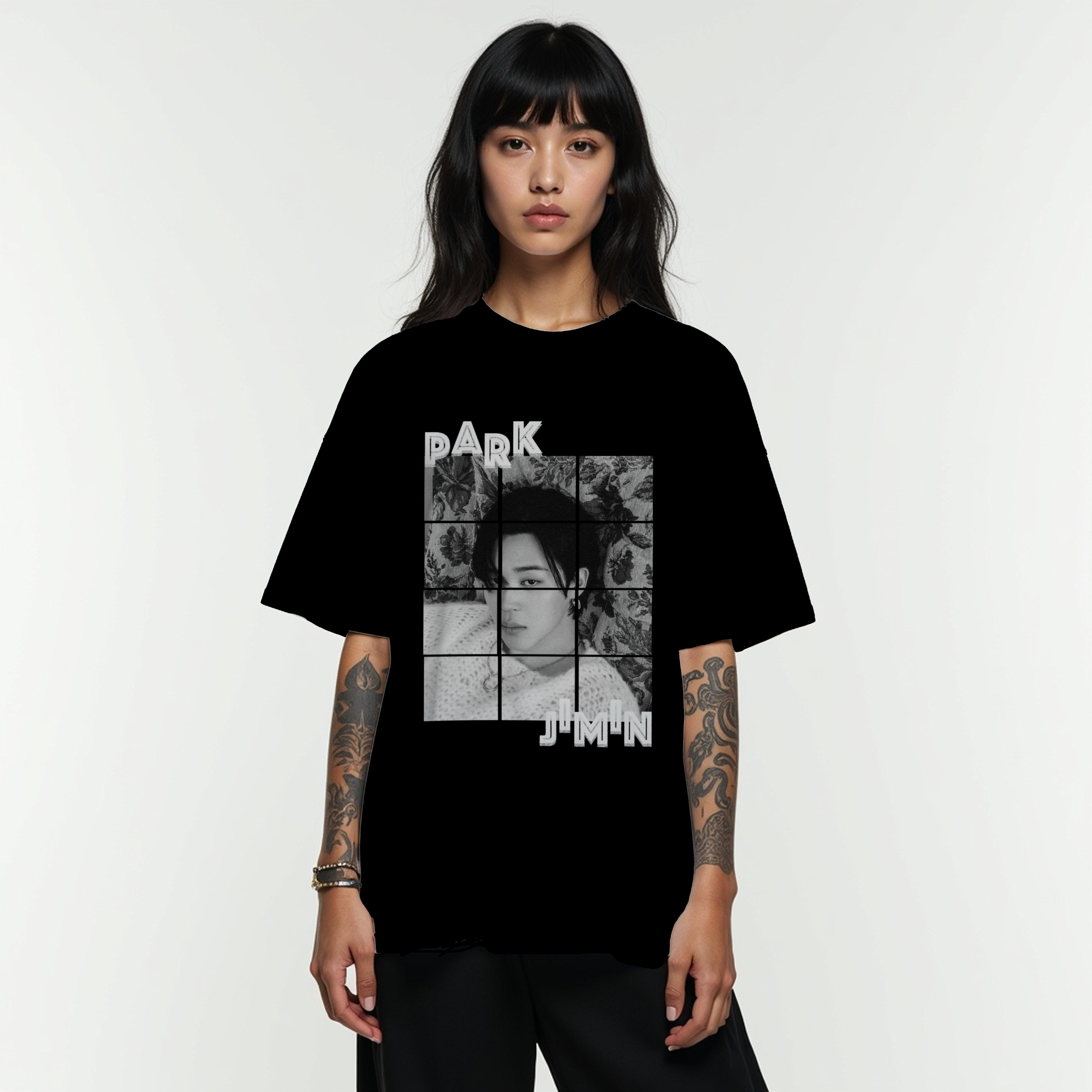 Person wearing a black t-shirt with Park Jimin of Bts graphic design on a white background