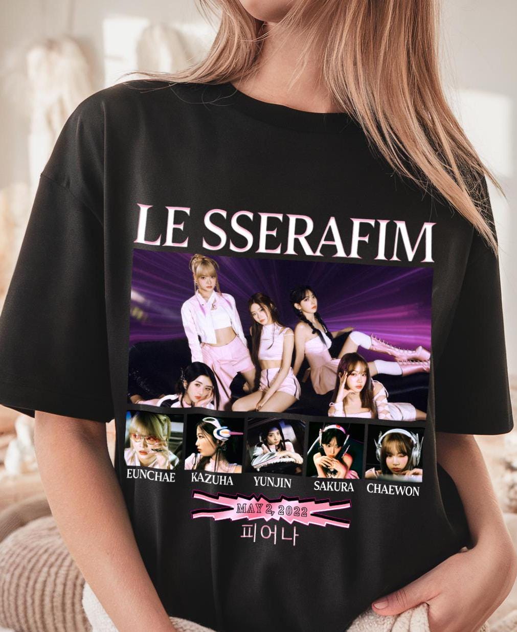 Black t-shirt with 'LE SSERAFIM' graphic design featuring members and text.