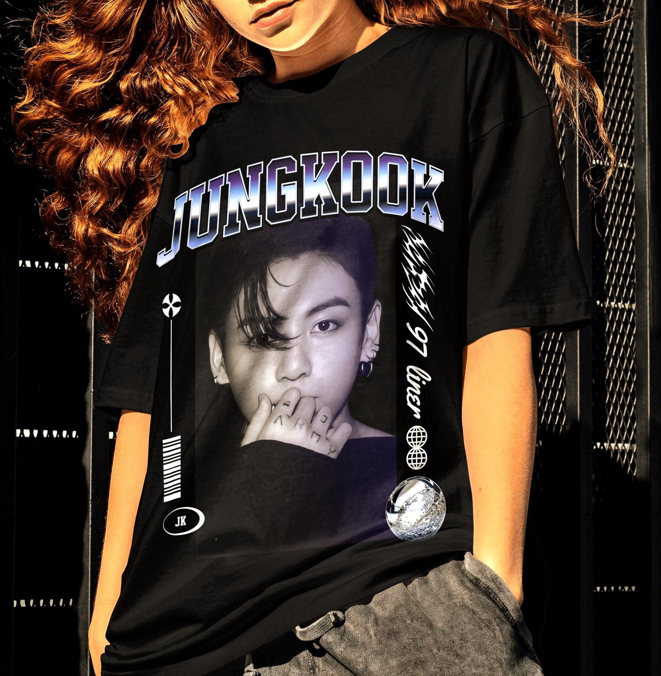 Person wearing a black t-shirt with a Jungkook of Bts graphic design and text