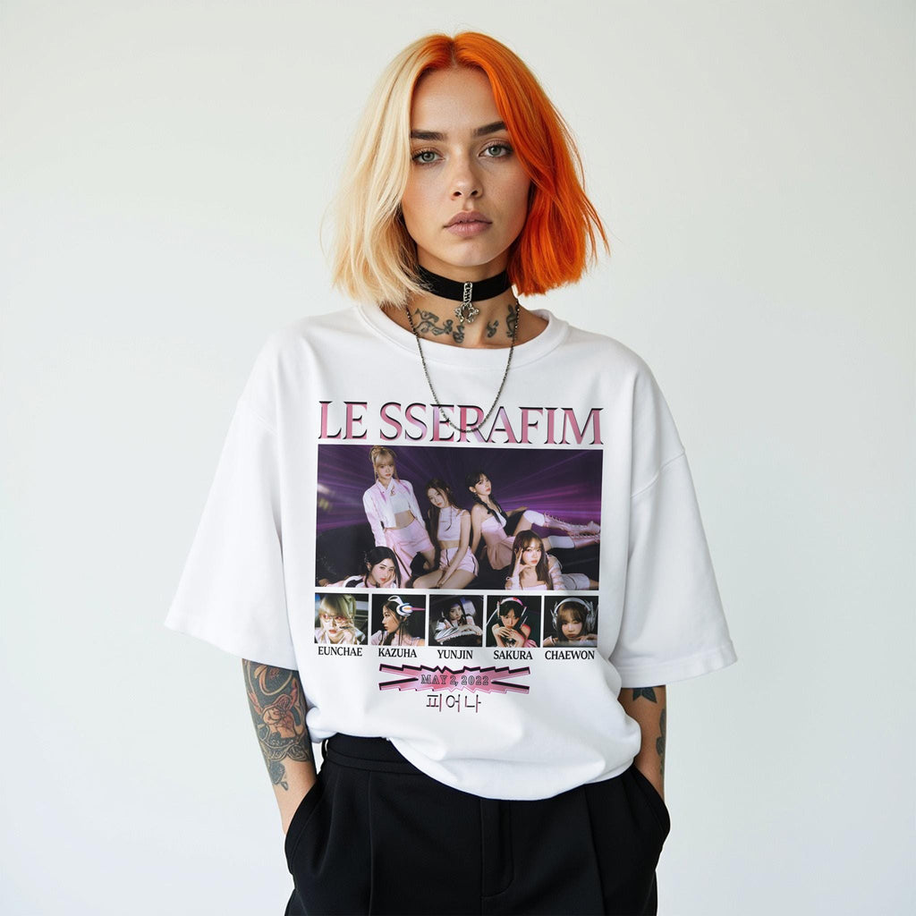 Person wearing a white t-shirt with 'LE SSERAFIM' design on a plain background